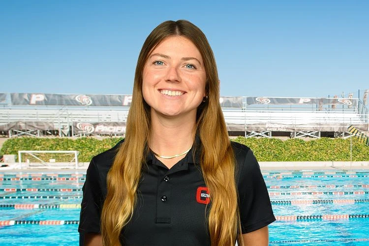 Candice Vorbeck smiling in front of a swimming pool